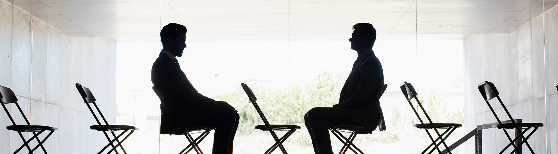 Silhouette businessmen sitting face to face