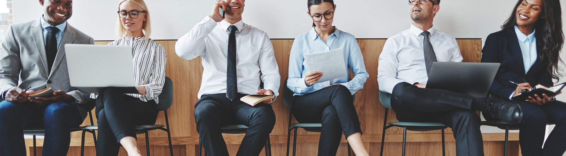 Smiling diverse busines people sitting together in an office rec